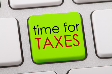 Time for taxes written on computer keyboard.