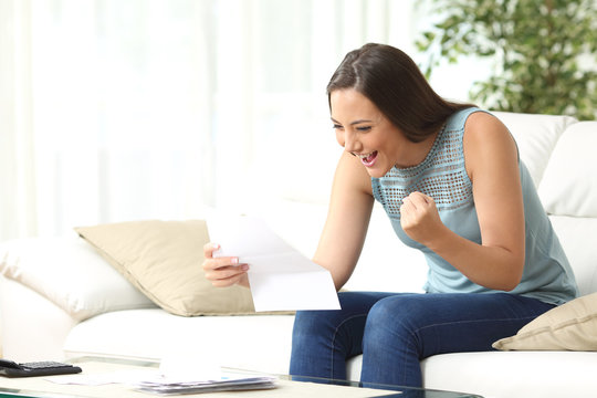 Excited woman reading good news in letter