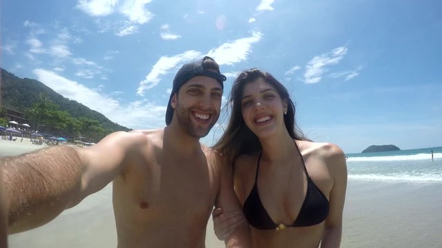 Couple taking a selfie and having fun in a Beach in Brazil