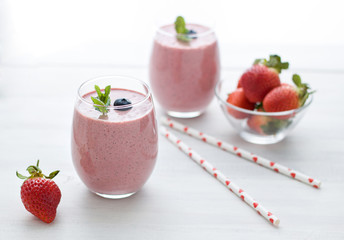 Stylish glasses of healthy smoothies with strawberry and blueberry. Morning breakfast for two. Valentines day drink