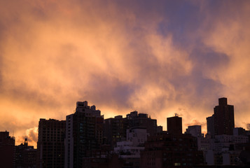 Dark silhouette tops of Manhattan cityscape, bright purple-orang - 132756718