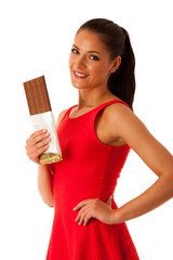 Beautiful young woman eats chocolate isolated over white backgro