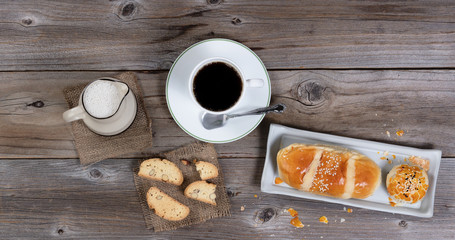 Morning pastry meal and coffee on rustic table