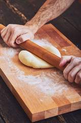 Making handmade pasta with wooden rolling pin