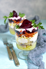 Traditional festive russian herring salad in a glass.