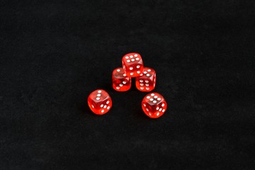 red dice on black background