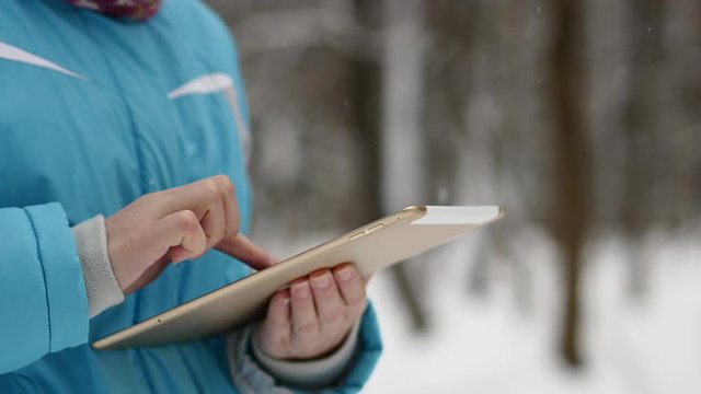 Woman Search On The Map In Tablet. Winter Forest, Snowy Weather Day