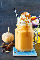 Healthy pumpkin spice smoothie with cream and caramel