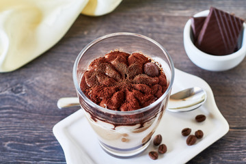 Tiramisu, traditional Italian dessert in glass, close up