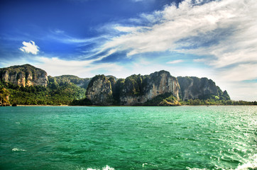 Ocean, limestone rocks and blue sky in Thailand