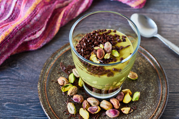 Elegant oriental dessert in a glass, pistachio mousse with chocolate