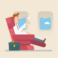 Businessman or manager sitting in an airplane in business class. Man drinking champagne.