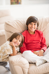 Child inside interior of modern home sitting on sofa