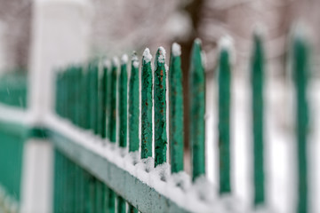 Green fence on blurred background
