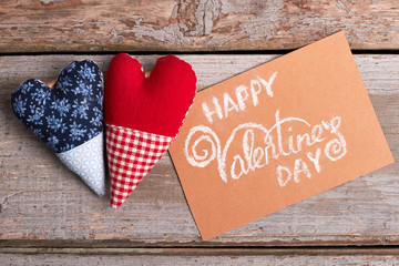 Valentine's Day card and hearts. Fabric hearts on wooden background. The magic of love.