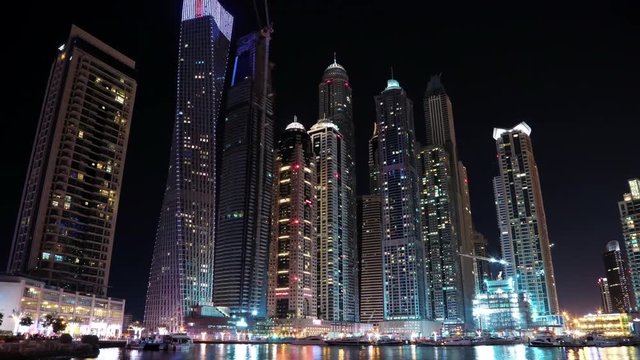 Dubai Marina night time lapse, United Arab Emirates. Dubai Marina - the largest man-made marina in the world. Dubai Marina is a canal city, carved along a 3 km stretch of Persian Gulf shoreline, UAE