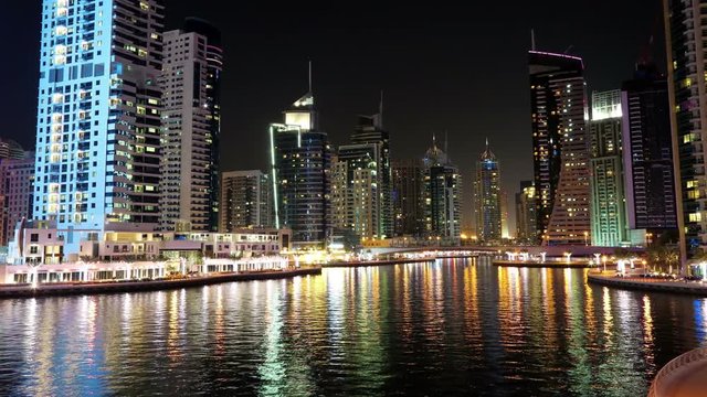 Dubai Marina night time lapse, United Arab Emirates. Dubai Marina - largest man-made marina in the world. Dubai Marina is a canal city, carved along a 3 km stretch of Persian Gulf shoreline, UAE