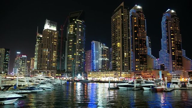 Dubai Marina night zoom timelapse, United Arab Emirates. Dubai Marina - largest man-made marina in the world. Dubai Marina is a canal city, carved along a 3 km stretch of Persian Gulf shoreline, UAE