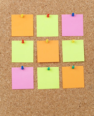 Colorful note papers pinned on a cork board