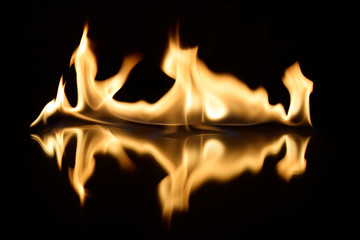  flames on a black background with mirror reflection