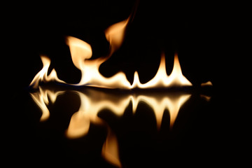  flames on a black background with mirror reflection