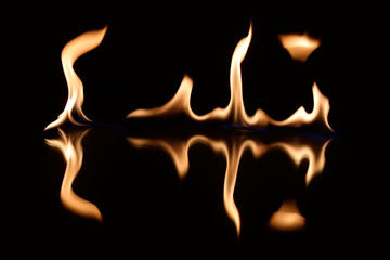  flames on a black background with mirror reflection