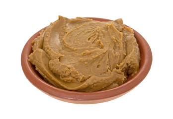 Cookie butter in a bowl on a white background.