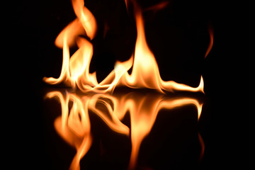  flames on a black background with mirror reflection