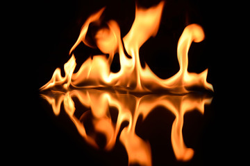 flames on a black background with mirror reflection