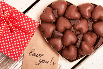 Box of chocolates near card. Gift box with star pattern. Recipe of good mood.