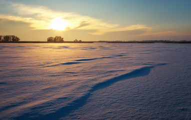 Fototapeta na wymiar Beautiful winter landscape with lake and sunset sky. 