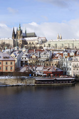 Fototapeta premium Snowy freeze Prague Lesser Town with gothic Castle above River Vltava, Czech republic