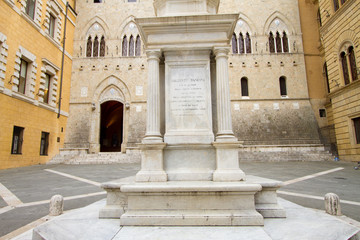Fototapeta na wymiar Siena, January 2017: Sallustio Bandini monument and the main Ga