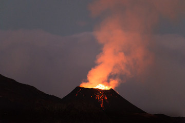 Ile de la reunion island Piton de la fournaise volcano eruption with lava flow and steam at night - 132766774