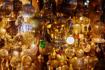 Fototapeta na wymiar Shining moroccan metal lamps in the shop in medina of Marrakesh, Morocco