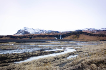 Iceland landscape Seljalandsfoss in winter with mountains and snow