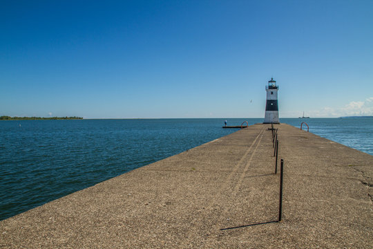 Lighthouse at the End of a Concrete Pier or Boat Dock