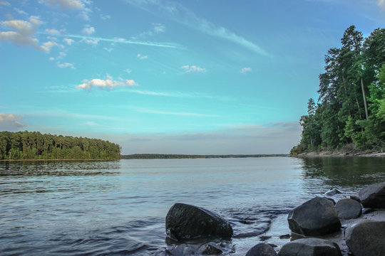 Rocky Shore at Calm Lake with Blue Sky