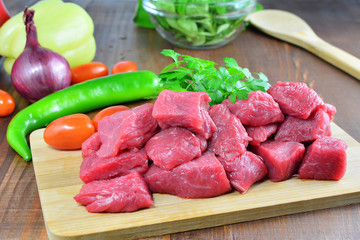 Cooking goulash with beef meat and vegetables