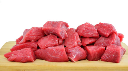 Diced raw meat on wooden board isolated