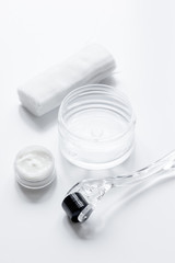 concept cosmetologist desktop with mezoroller - mesotherapy on white background