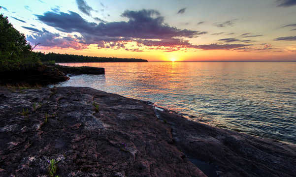 Scenic Sunset Over The Inland Sea. Sunset over the horizon of Lake Superior on the Pt. Abbaye  Peninsula.  The point is a preserve maintained by the Michigan Nature Association. L'Anse, Michigan.