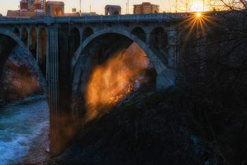 Sun shining through steam under the Monroe Street Bridge in Spokane