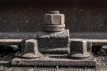 Obraz na płótnie Canvas old rusty screw , iron bolts on railway