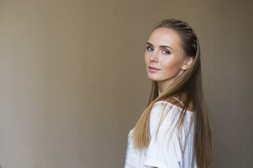 pretty young woman in the romantic mood looking though her shoul