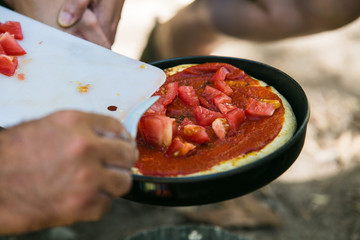 Food being prepared on a camping trip with small camping sized equipment