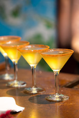 Row of fancy yellow drinks at a party