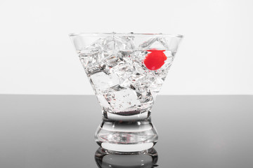 Sparkling beverage in a martini glass with a cherry