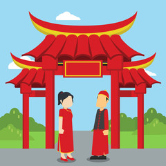 chinese man and women standing infront of chinese gate