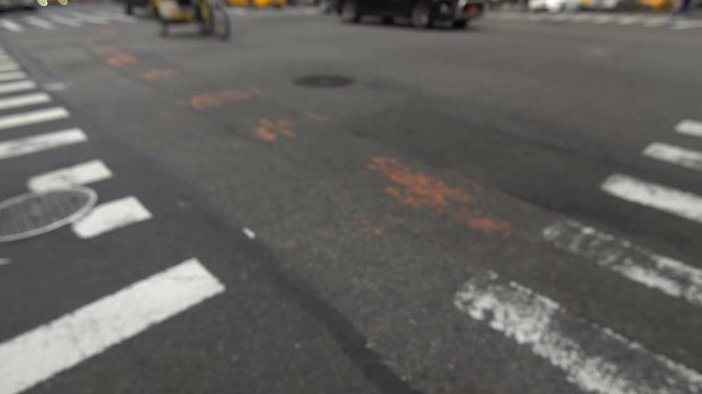 Defocused New York City street intersection, yellow taxi vehicles passing by, low angle shot NYC motion background